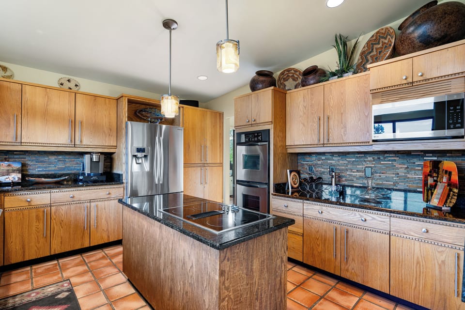 The gourmet kitchen is fully stocked, featuring modern appliances perfect for crafting delicious meals.