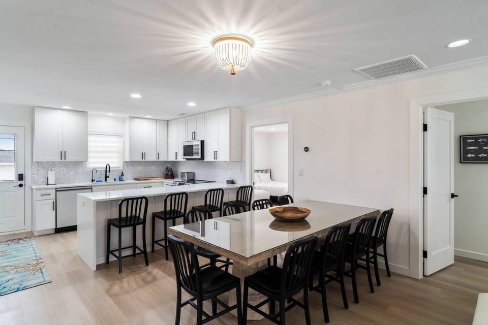 Stainless steel appliances, oven, stove, microwave, dishwasher, refrigerator/freezer, coffee maker, toaster, blender, wine glasses, full dining set, BBQ utensils, outdoor plates, baking & cooking essentials, plus Alexa for music.