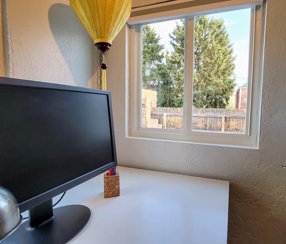 The office has great light and looks out on the courtyard and lovely evergreens.