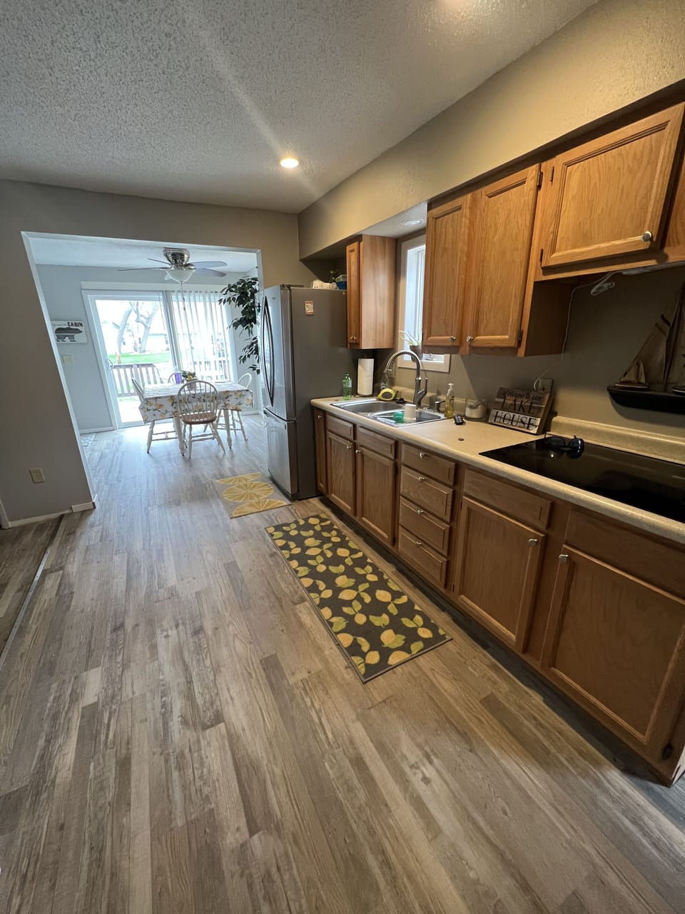 The kitchen has a stove top and refrigerator
