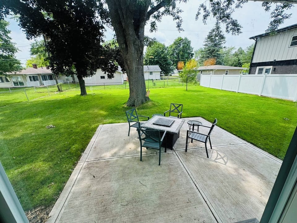Large fenced in backyard with walk out patio, including firepit