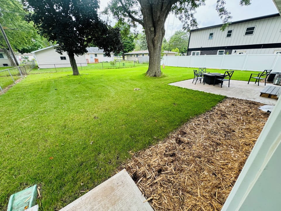 Large fenced in backyard with walk out patio