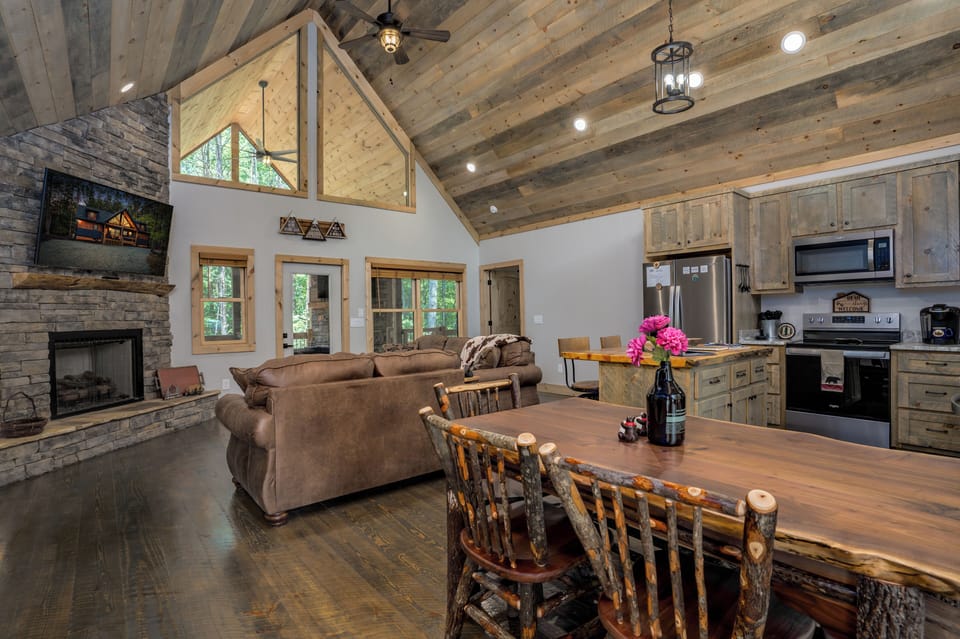 View of the open concept fam rm, breakfast area, kitchen & Gas log fireplace.