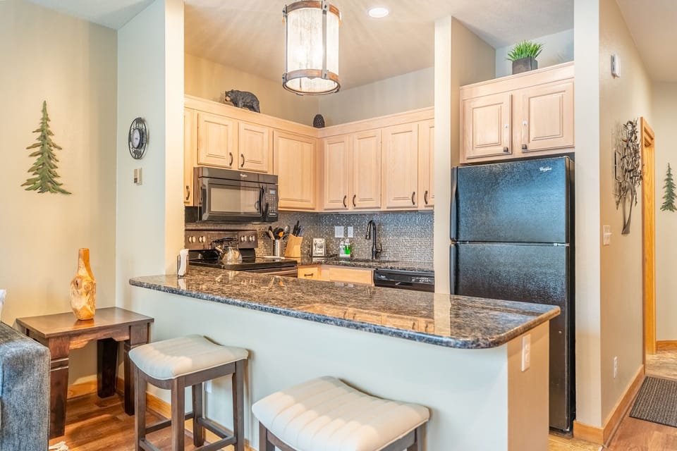 Kitchen and breakfast bar with additional seating for two.