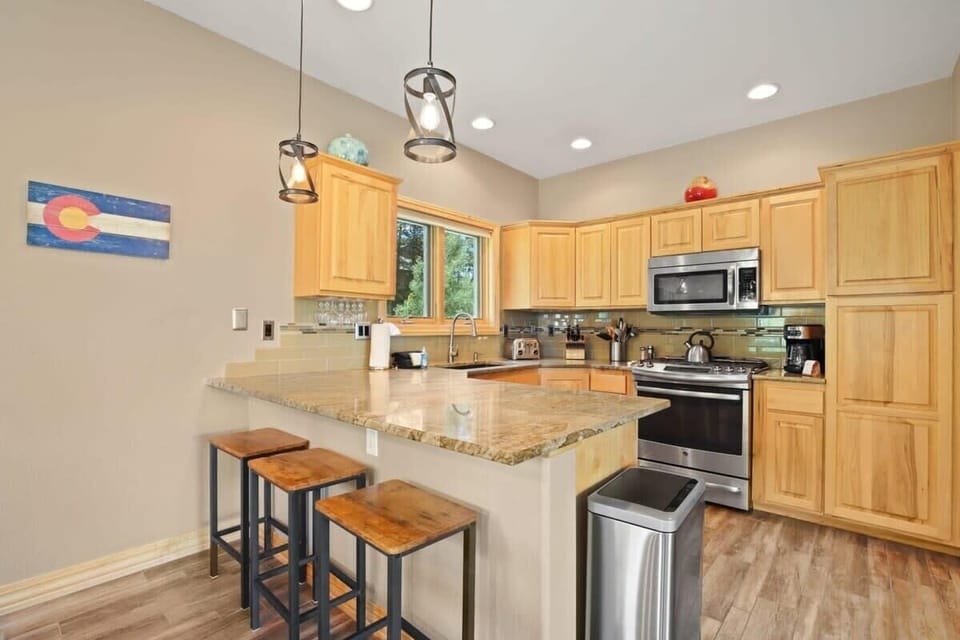 The stunning kitchen boasts stainless steel appliances, granite countertops and abundant cabinet space. It is stocked with everything you need to whip up a meal, including a blender, toaster, tea kettle and coffee maker.