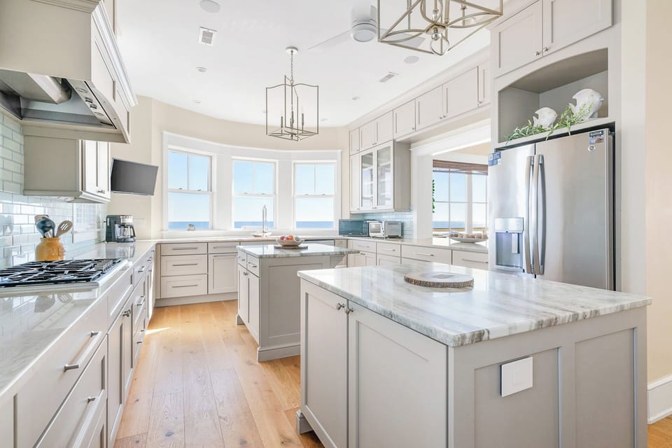 The spacious kitchen features two large islands, providing plenty of room for meal preparation.