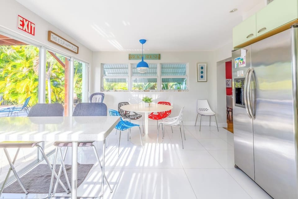 Bright dining area with colorful chairs and garden view—perfect for family meals