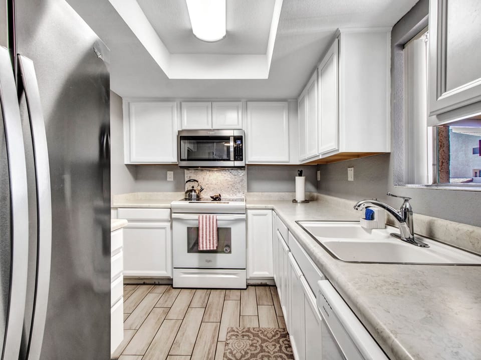 Full size kitchen with electric range & oven, microwave and tea kettle