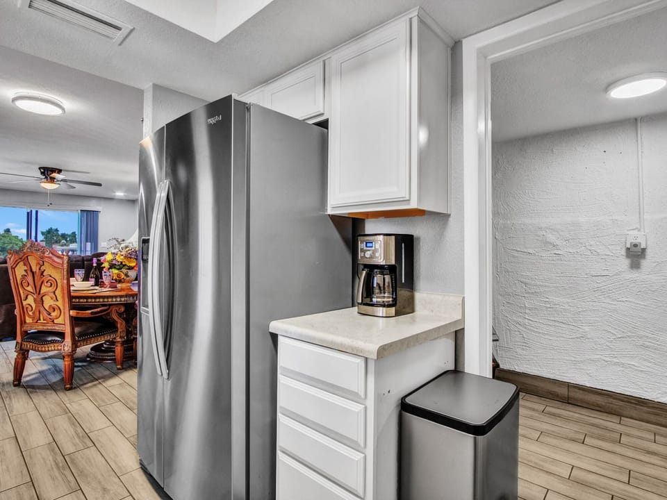 Refrigerator with ice and water dispenser, drip coffee maker & laundry entrance