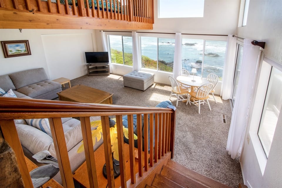 Living room is located in the lower area of the common areas, accessed by stairs