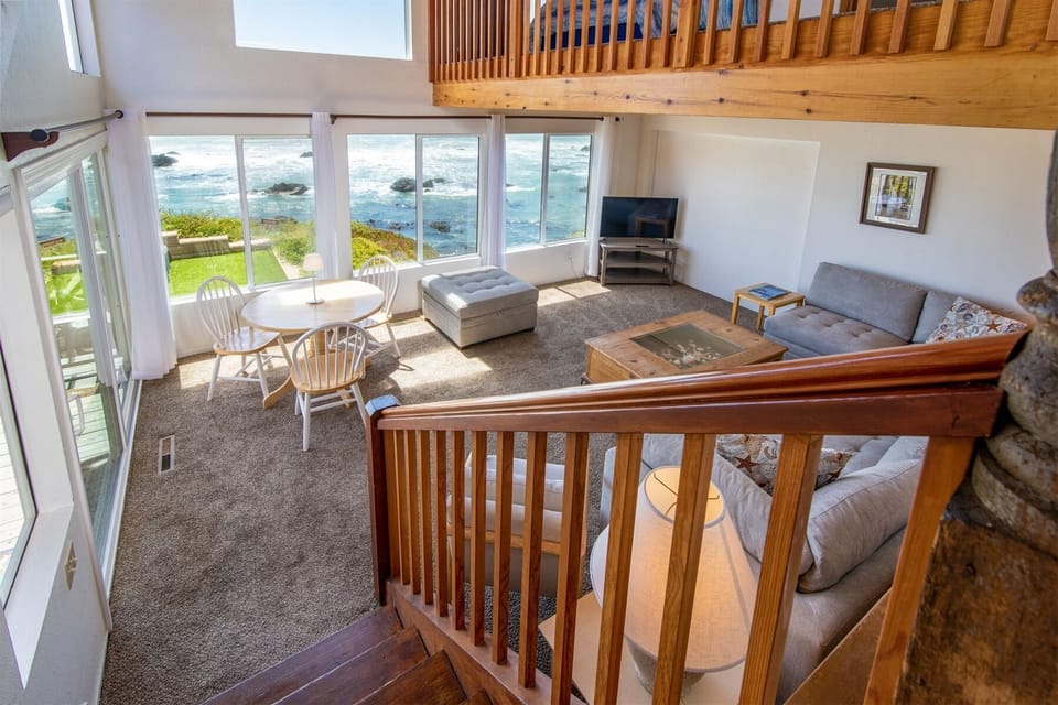 Living room is located in the lower area of the common areas, accessed by stairs