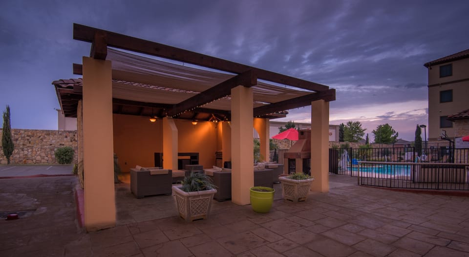 Outdoor seating area with pool view.
