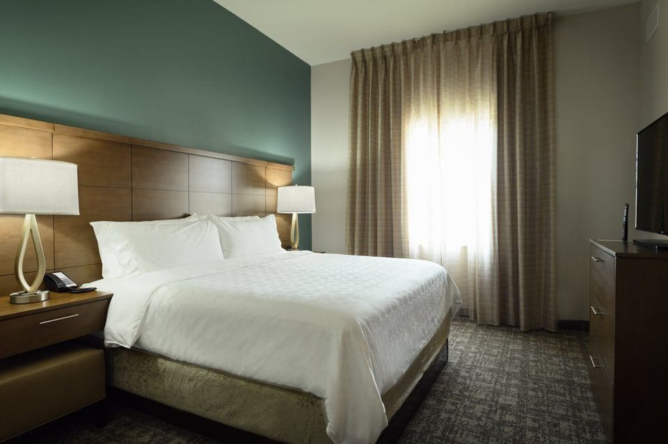 The king bedroom is elegantly designed with soft lighting and a large window for natural illumination.
