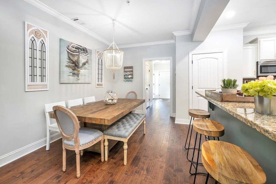 Dining area with wood table, bench, and chandelier
