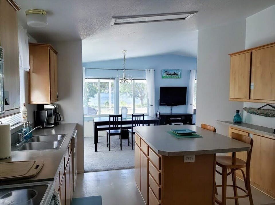 The well-equipped roomy kitchen is open to the living area and includes the view