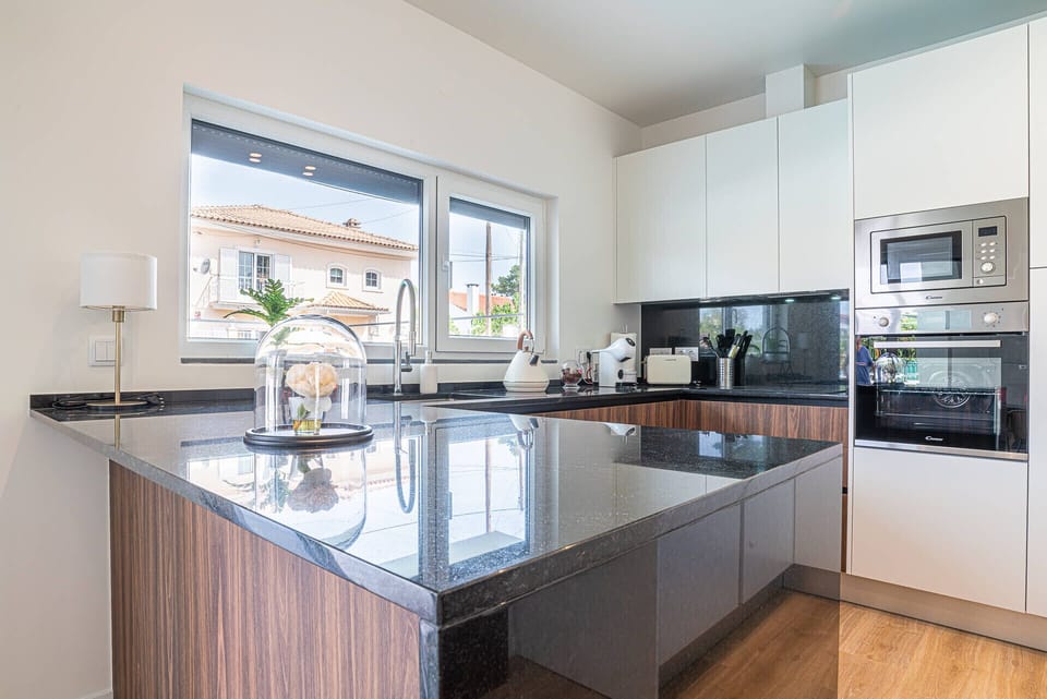 Modern kitchen with dark granite island countertop — Villa Cuca, luxury holiday villa in Marisol