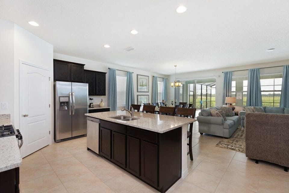 Kitchen with stainless steel appliances, granite counters and island