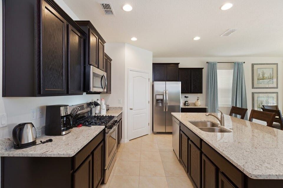 Kitchen with stainless steel appliances, granite counters and island