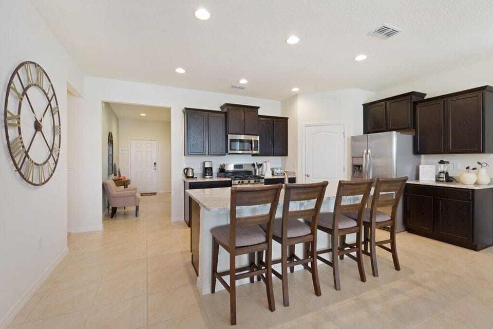 Kitchen with stainless steel appliances, granite counters and island