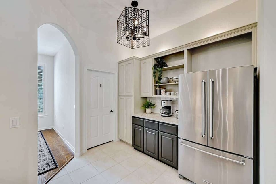 Large fridge and freezer with coffee station.