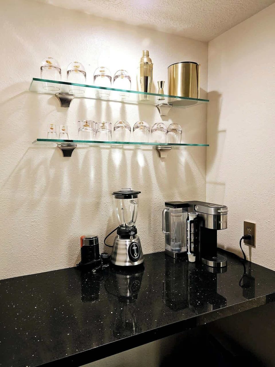 Beautiful bar area with coffee maker, blender, coffee grinder, and bar tools. 