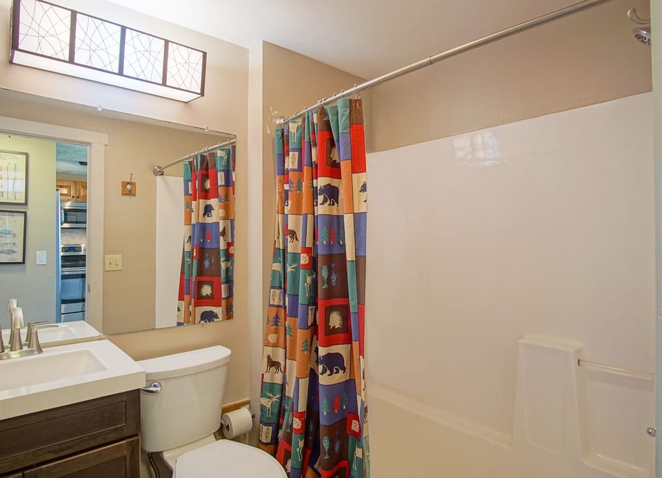 This is a shared bathroom on the main level located off from the kitchen.
