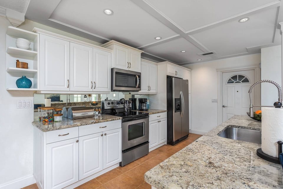 The updated kitchen is a chef's. dream with all the space he/she will have to move about, plus it's open to everything!