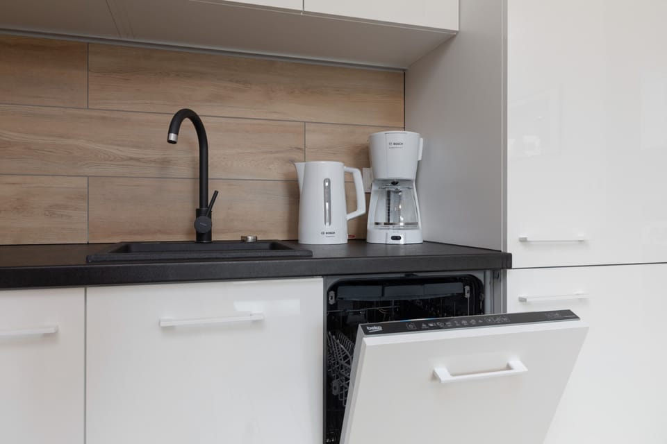 Kitchenette with oven and refrigerator. 