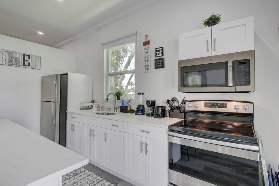 There are Quartz Counters, Stainless Appliances and There is a Nice Window to Look Outside in the Kitchen