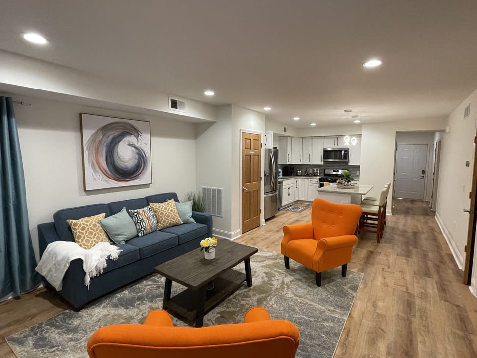 Open concept living/dining/kitchen area. Note pull-out sofa with queen size bed.