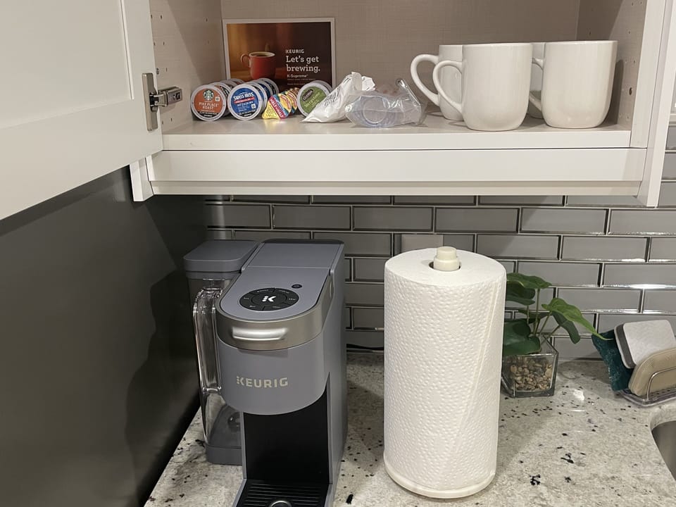 Coffee station with Keurig Coffee Maker and starter Starbuck's tea, coffee pods.