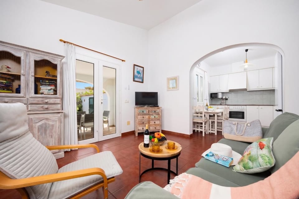 Open-plan living room with sofa, dining area, kitchen, WiFi internet, and satellite TV