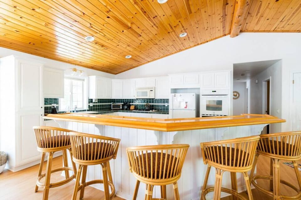 Our spacious kitchen is fully stocked and opens up to the living + dining room,