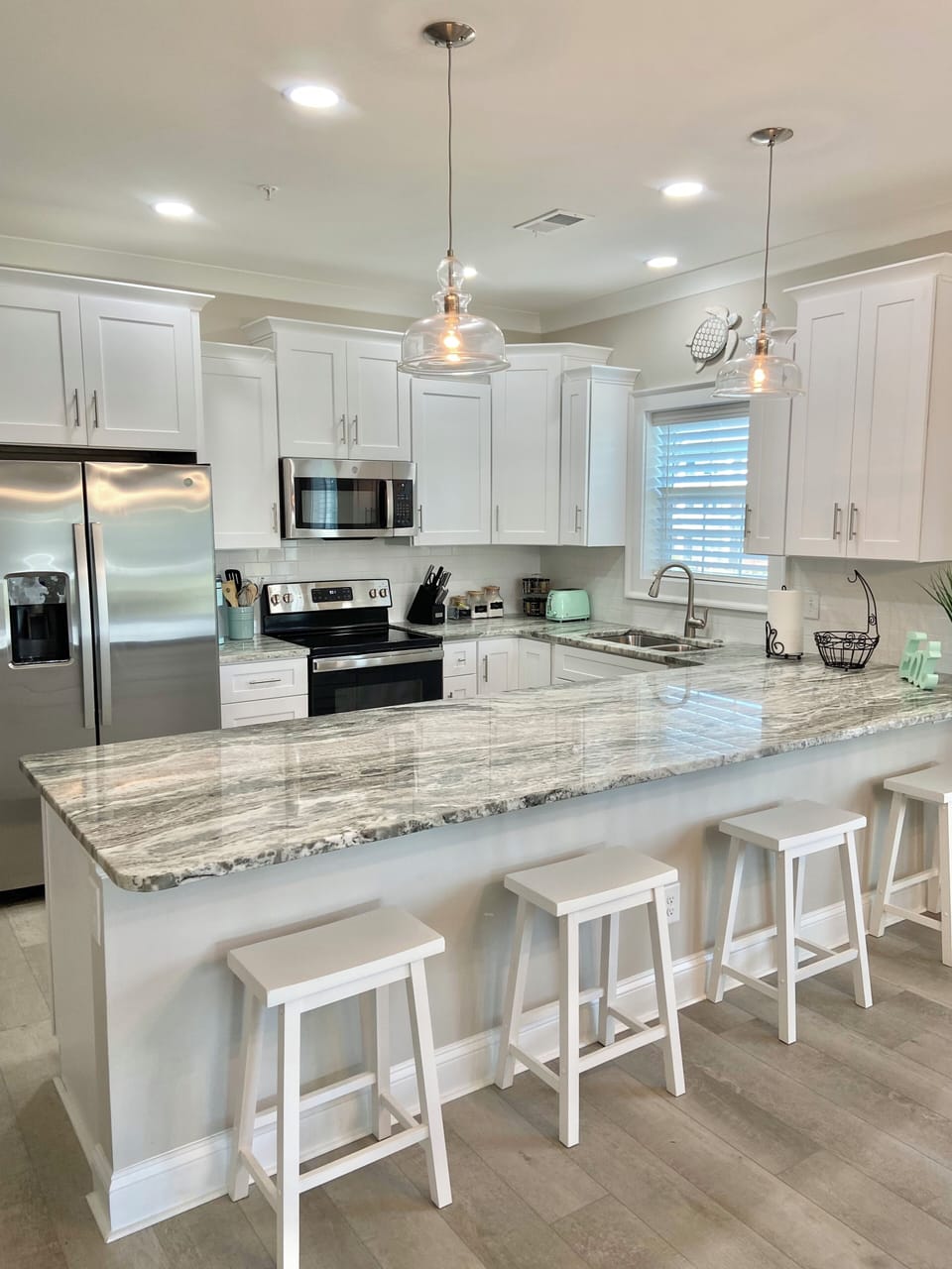 Light filled kitchen with gleaming granite counters and HUGE island/counter.