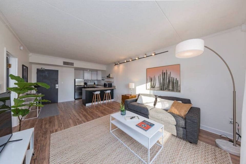Open living room/kitchen concept. There are now 4 seats at the kitchen counter area.