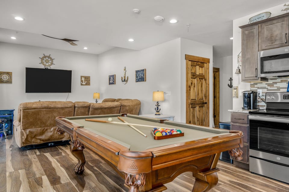 Game area with pool table and 70" smart TV