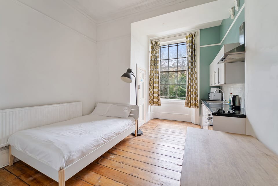 A cosy private bedroom filled with natural light and a dedicated private kitchen for your convenience.