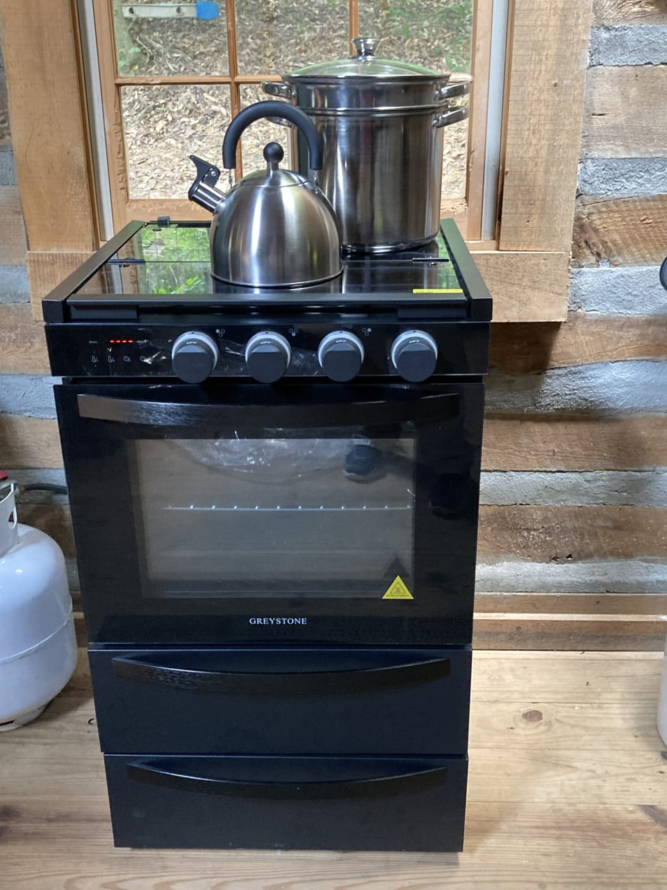 Propane range with 3 burners.  More pots and pans in the bottom drawer.
