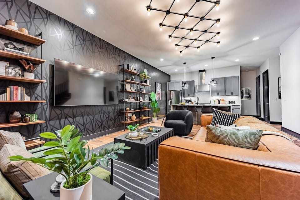 Unit 1: Extremely detailed spacious living area with designer luxury furnishings, 85 in flat screen TV, flooring from a 150 year old barn, custom murals/wall art, light fixtures and wall paper.