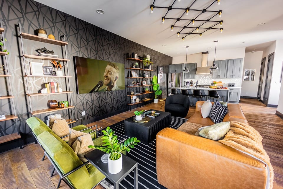 Unit 1: Extremely detailed spacious living area with designer luxury furnishings, 85 in flat screen TV, flooring from a 150 year old barn, custom murals/wall art, light fixtures and wall paper.