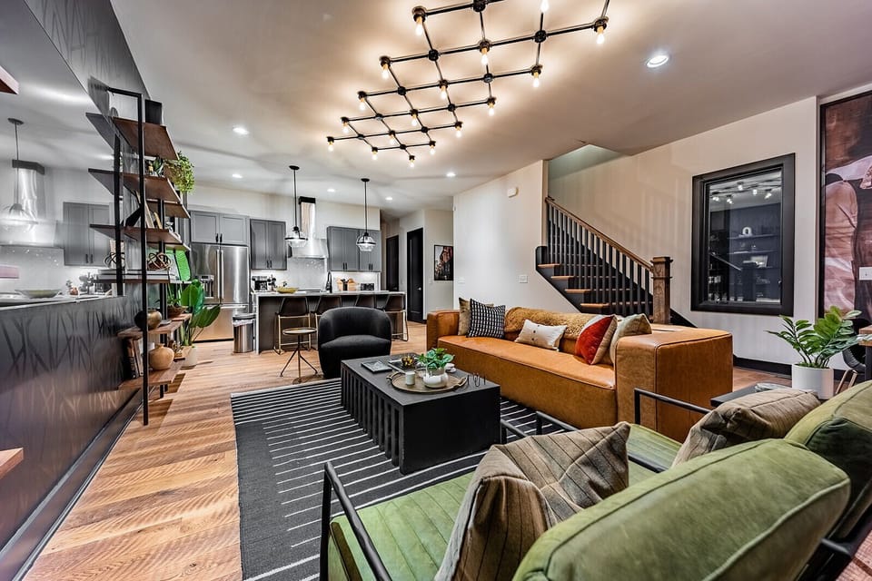Unit 1: Extremely detailed spacious living area with designer luxury furnishings, 85 in flat screen TV, flooring from a 150 year old barn, custom murals/wall art, light fixtures and wall paper.