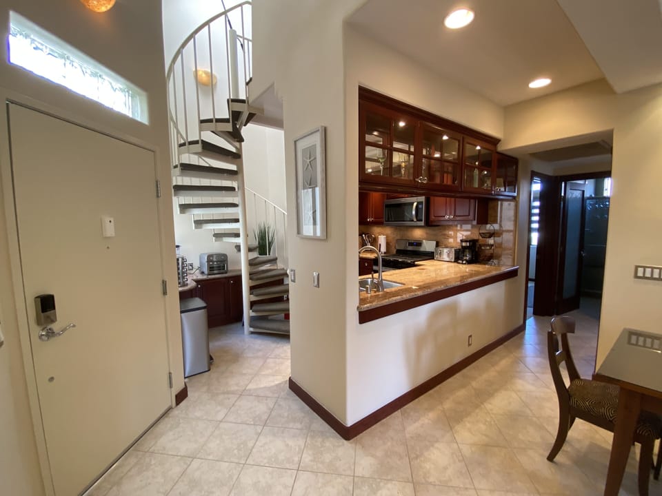 Hallway leads to beds/baths, stairs to loft bedroom & hm office