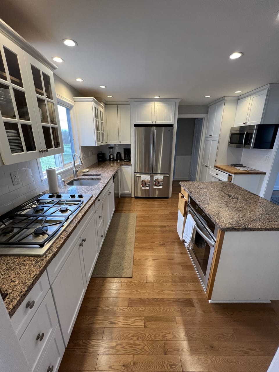 Gas cooktop, granite counters & stainless steel appliances appoint the kitchen.