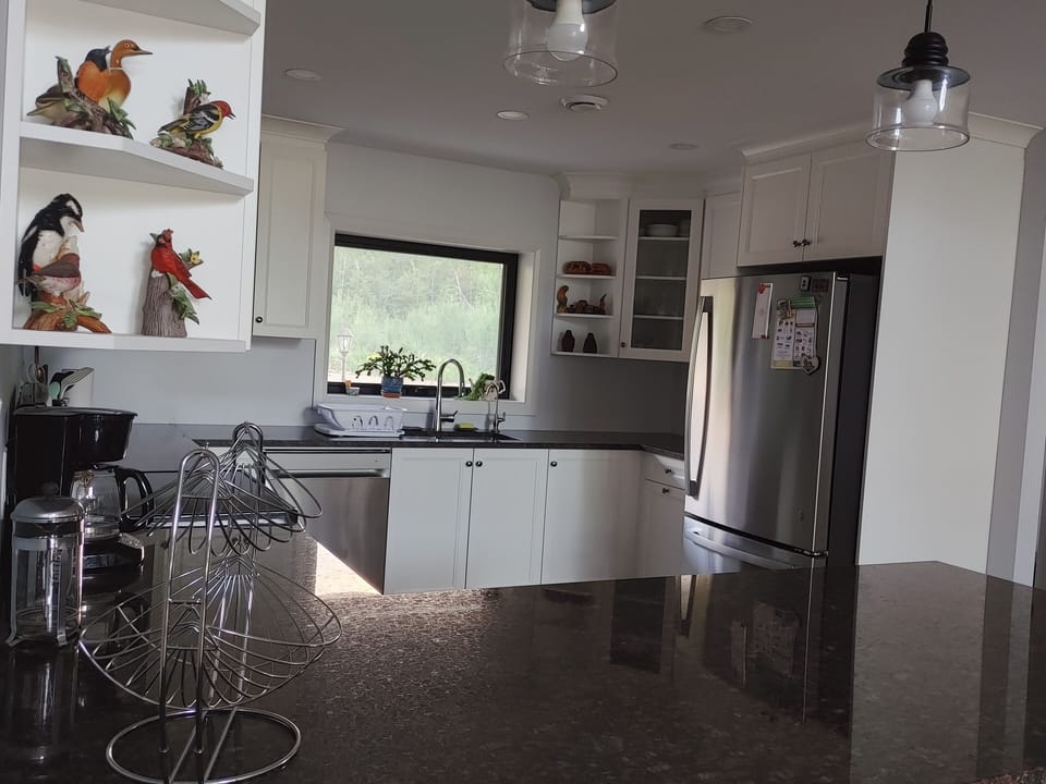 Spacious kitchen with granite countertops.