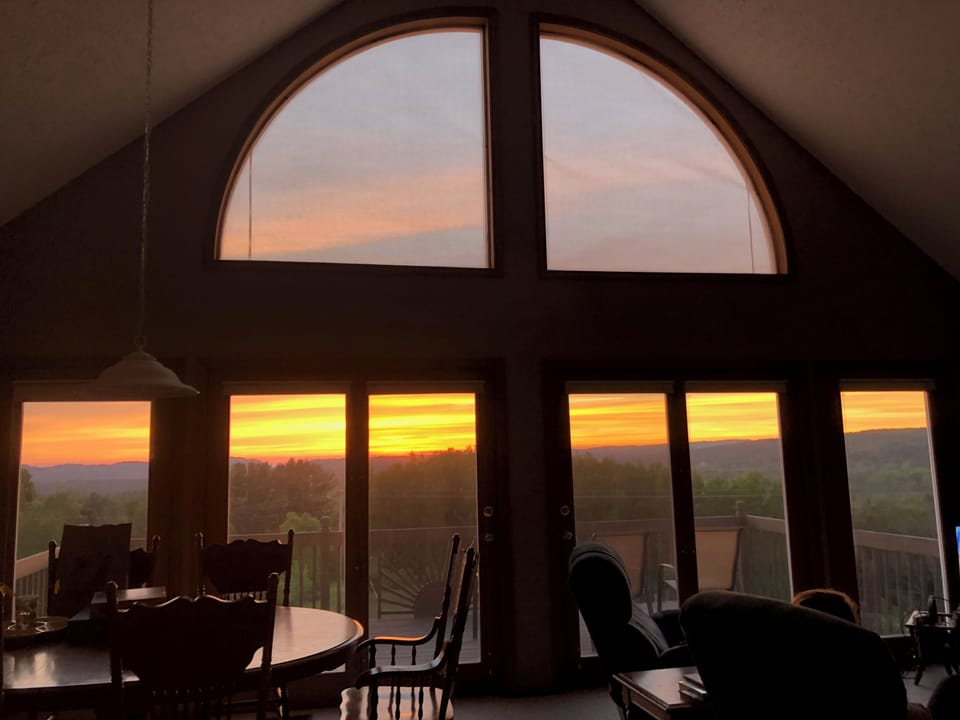 OVERALL:  The living room and deck with the sunset in the background