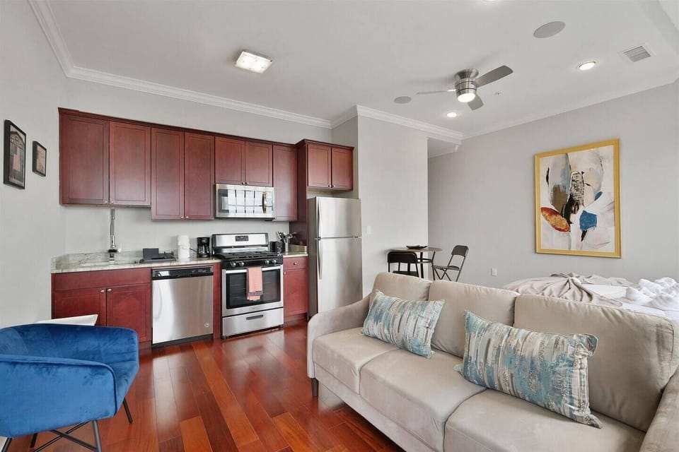 Studio overview showing open-concept layout with kitchen, living area, and abundant natural light.