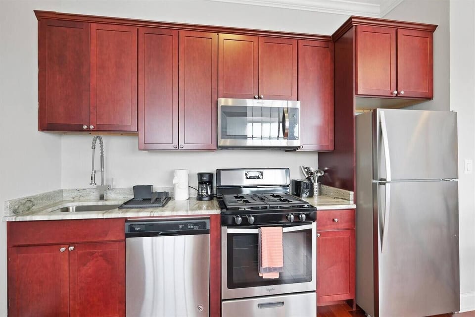 Full kitchen with gas range, microwave, oven, coffee maker, toaster, and ample counter space providing all the tools for delicious meals.