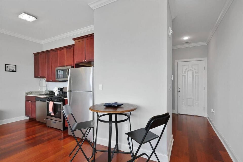 Dining area with round table and modern chairs perfect for meals or working remotely