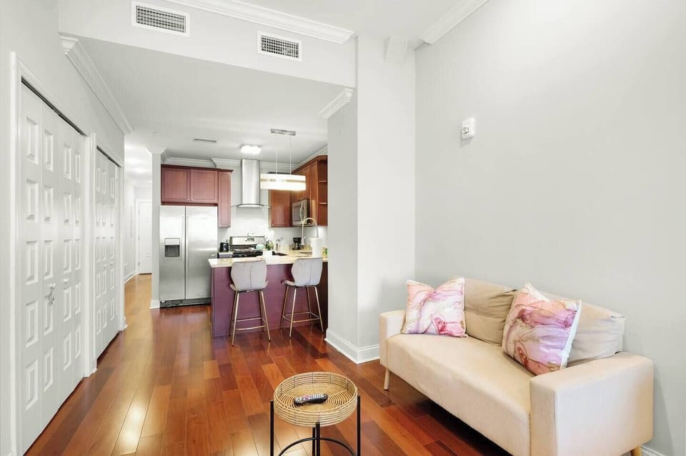 Dining area with accent chair and open layout maximizing space in this efficient studio design.