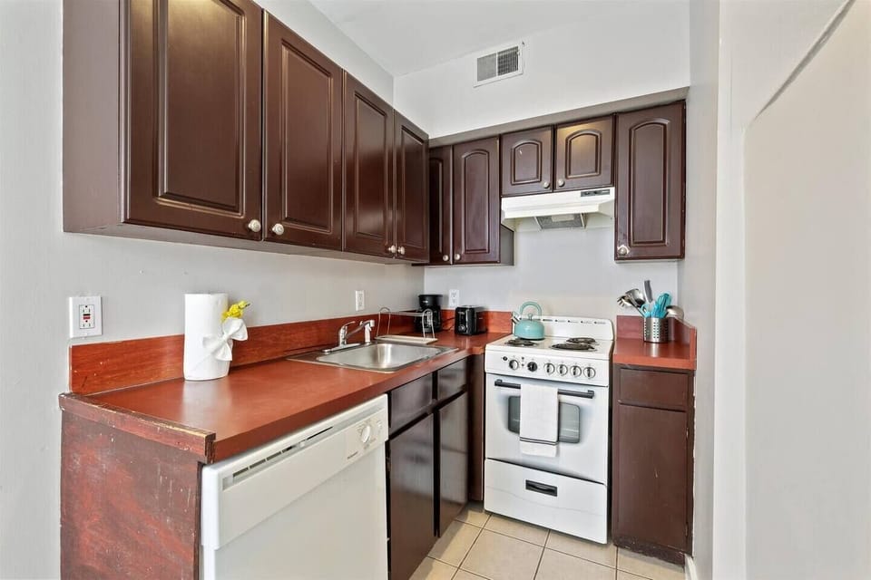Fully stocked kichen with stove, oven, microwave, toaster, coffee maker, dishes, pots and pans.